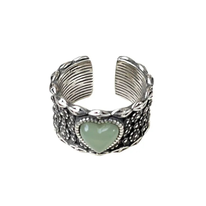 Retro wide-faced heart-shaped ring with adjustable opening in silver finish.