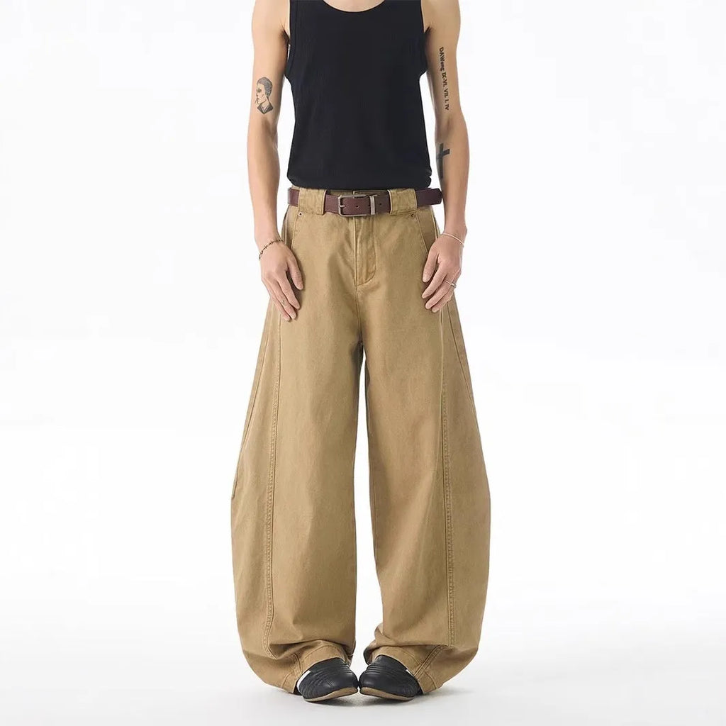 Man wearing brown loose-fit straight leg jeans with a mid waist and button fly.