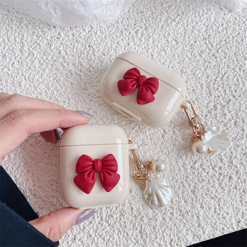 Beige red bow shell coloured TPU clamshell case cover for Apple AirPods charging case.