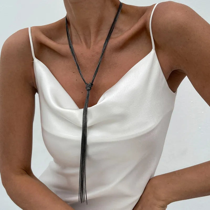 Simple Y-shaped metal tassel necklace with minimalist understated style, colour Gold, on display with matching earrings.