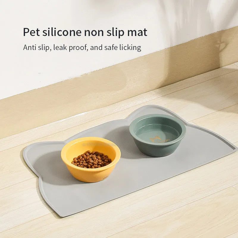 Silicone waterproof pet feeding mat with cat head design measuring 44x24cm in solid colours