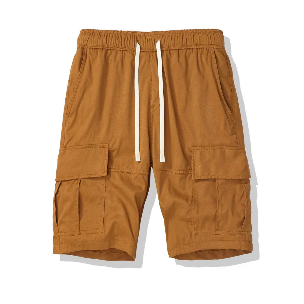Man wearing loose-fitting multi-pocket cropped trousers in a dark colour for summer casual style.
