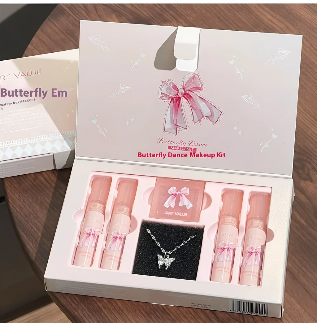 Butterfly Box makeup set with four lip mud tubes, powder blusher compact, and matching necklace on pink background
