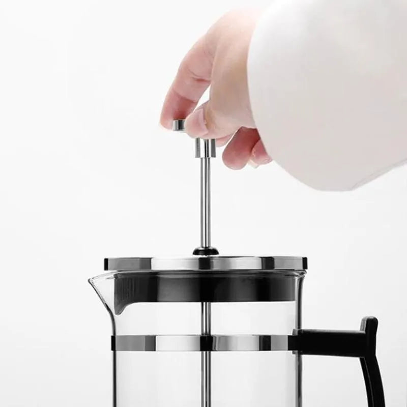 Compact glass and stainless steel manual pour-over coffee maker with 350ml capacity.