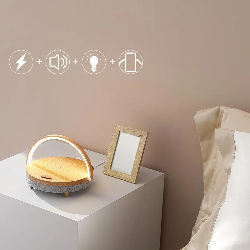 Wireless charging LED night light with Bluetooth speaker showing marble pattern finish and phone holder