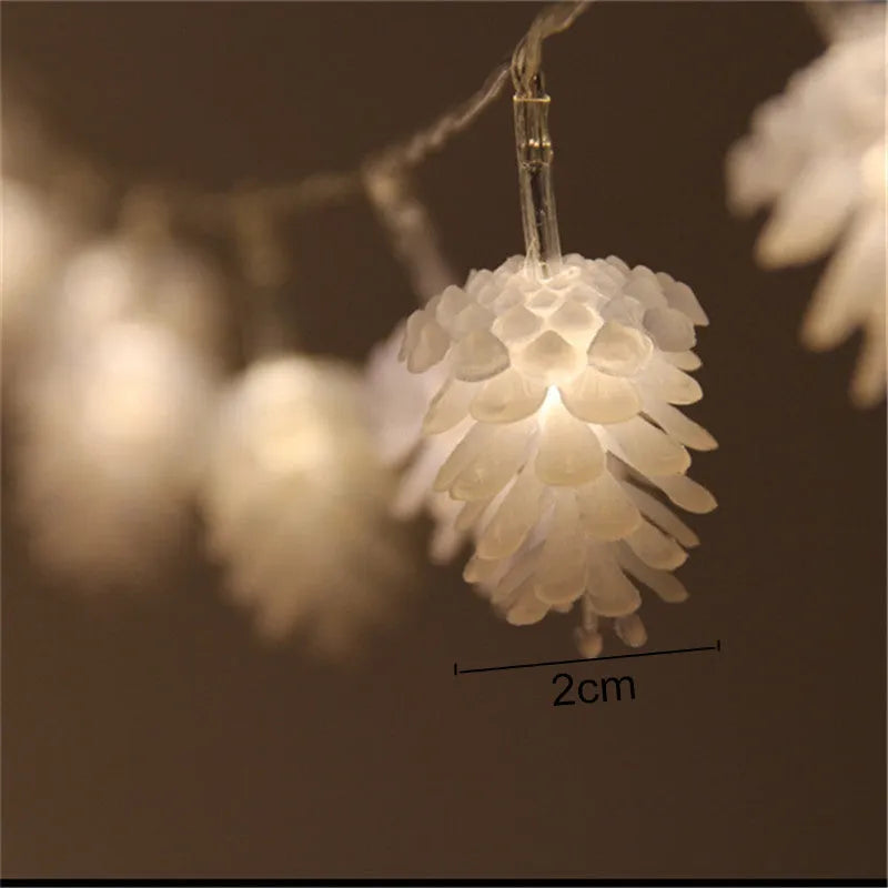 Battery powered LED pine cone light string in warm white colour with plastic shell construction