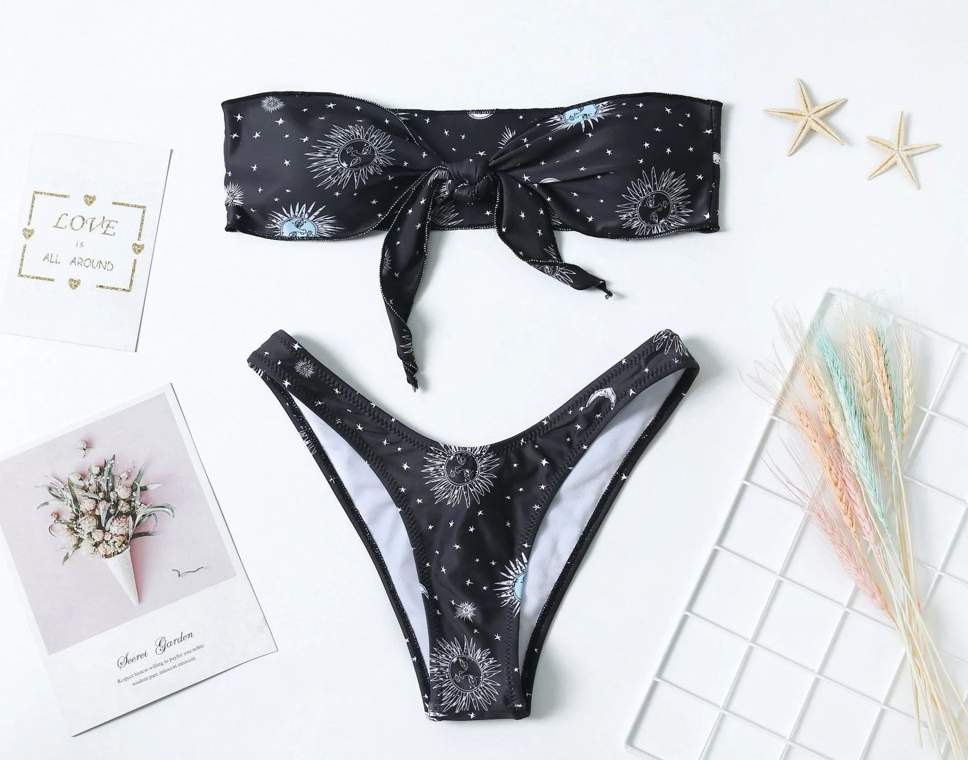 Black women's one-piece swimsuit with bikini print and split tube top backless design.