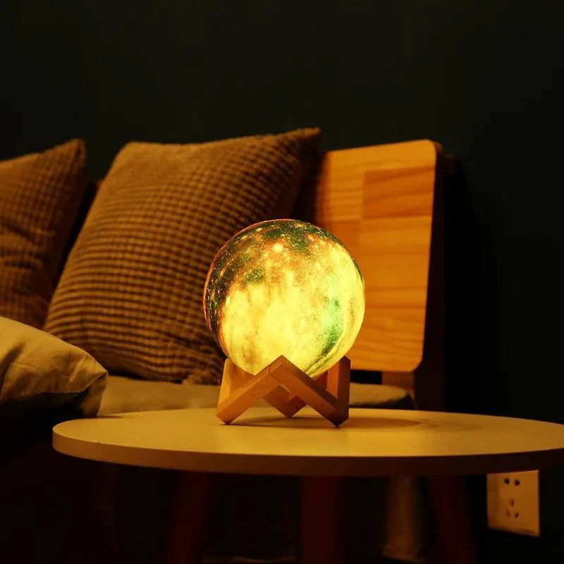 3D printed spherical lunar night light on a table showing colour-changing LED illumination.