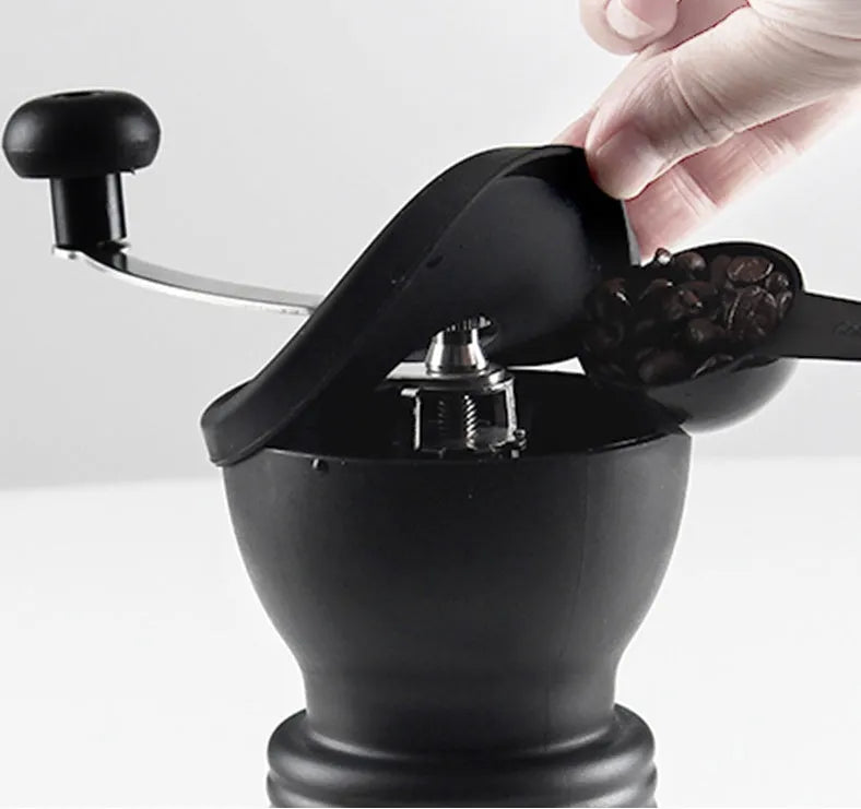 Beech wood hand grinder coffee machine with black finish, 88 mm wide, on a table