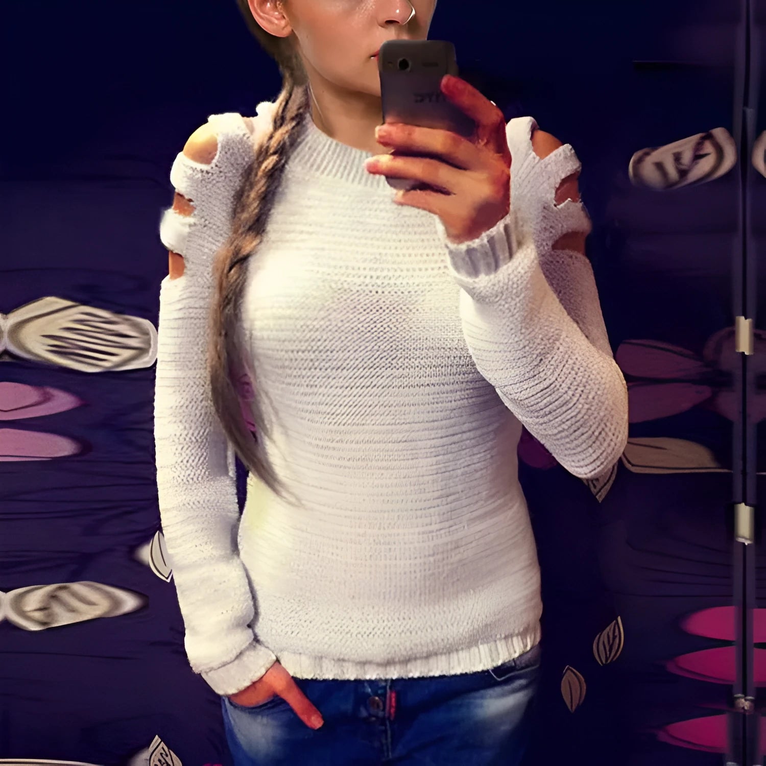 Women's white hollow-out crocheted knit long sleeve pullover shirt on a hanger.