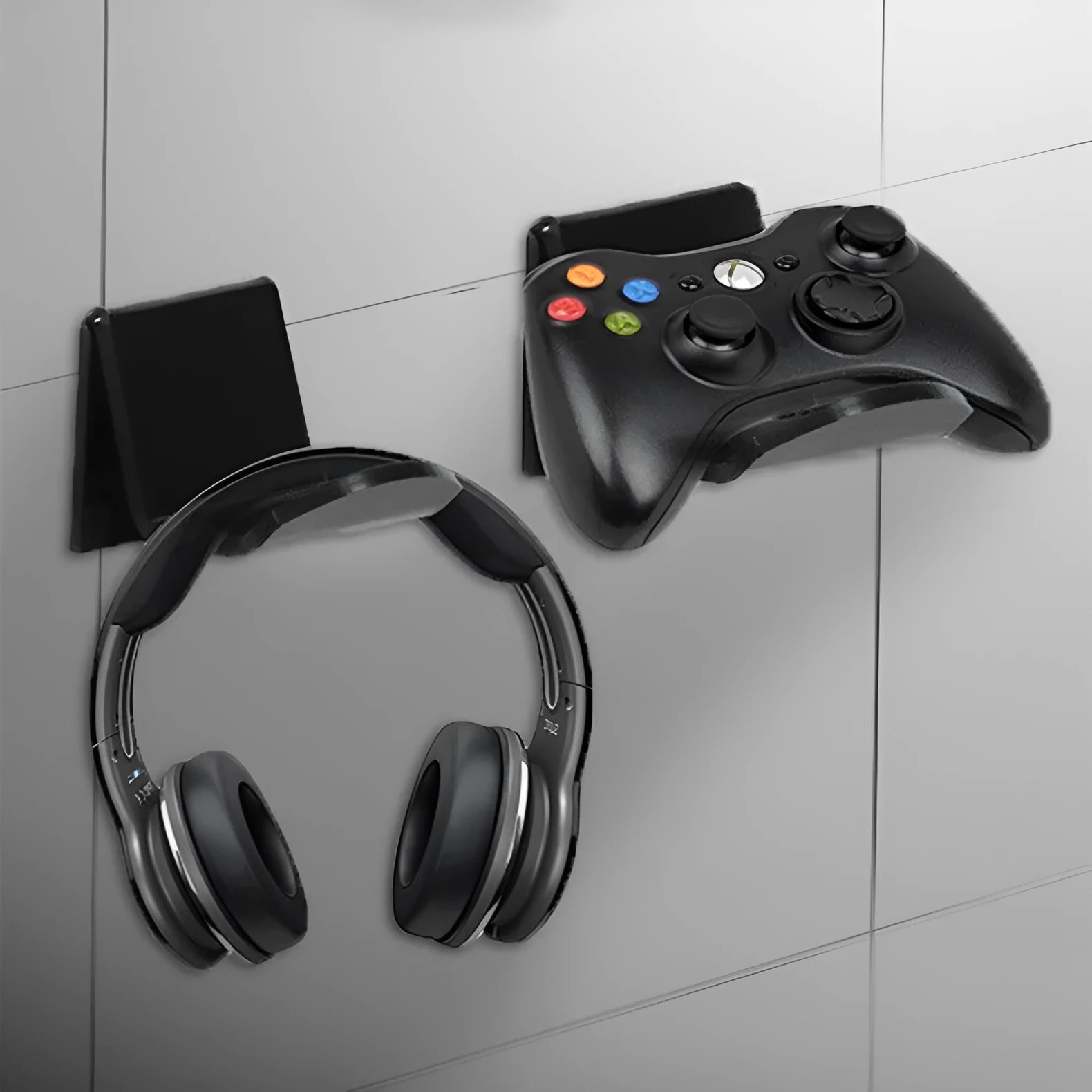 Universal plastic game controller bracket mounted on a wall in a choice of black, white, or transparent.