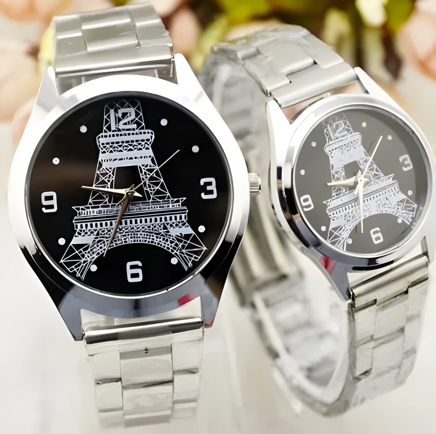 Eiffel Tower wrist watch with metal case and analogue display on metal strap with buckle closure.