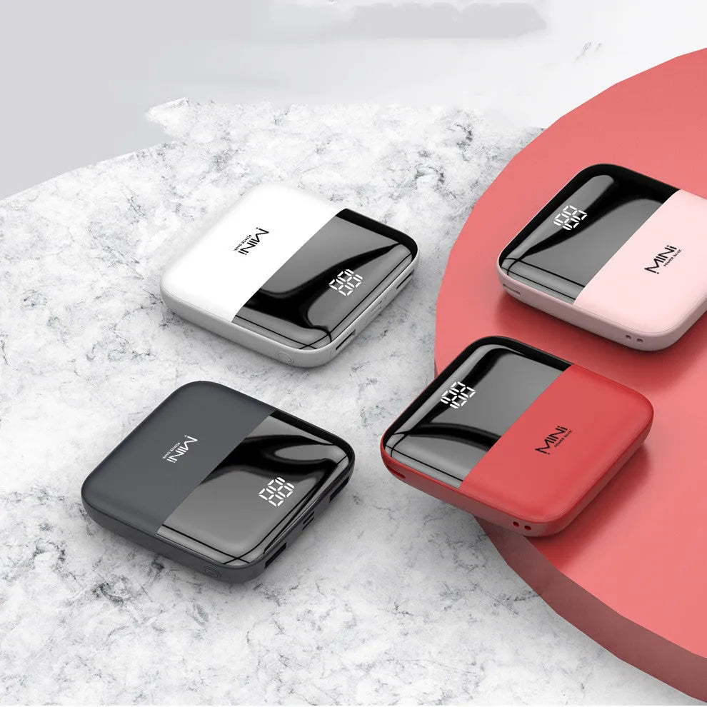 Black Android 10000mAh portable power bank with digital display showing battery percentage and dual USB ports.