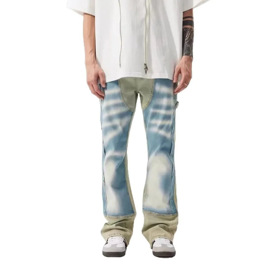 Retro patchwork jeans with splash-ink distressed design in yellow and blue colours