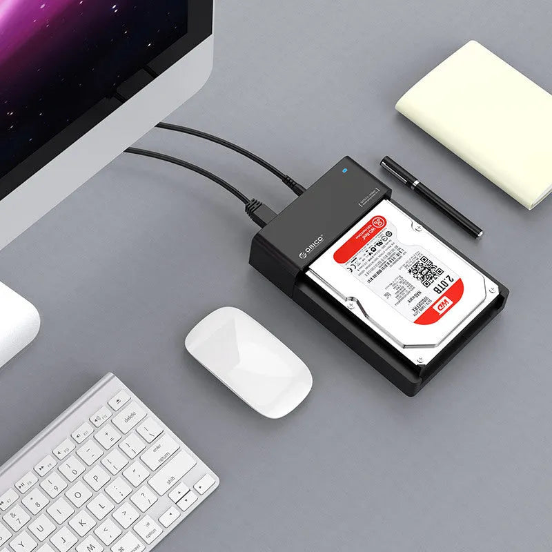 Black plastic universal hard disk enclosure for 2.5-inch and 3.5-inch SATA drives with data cable.