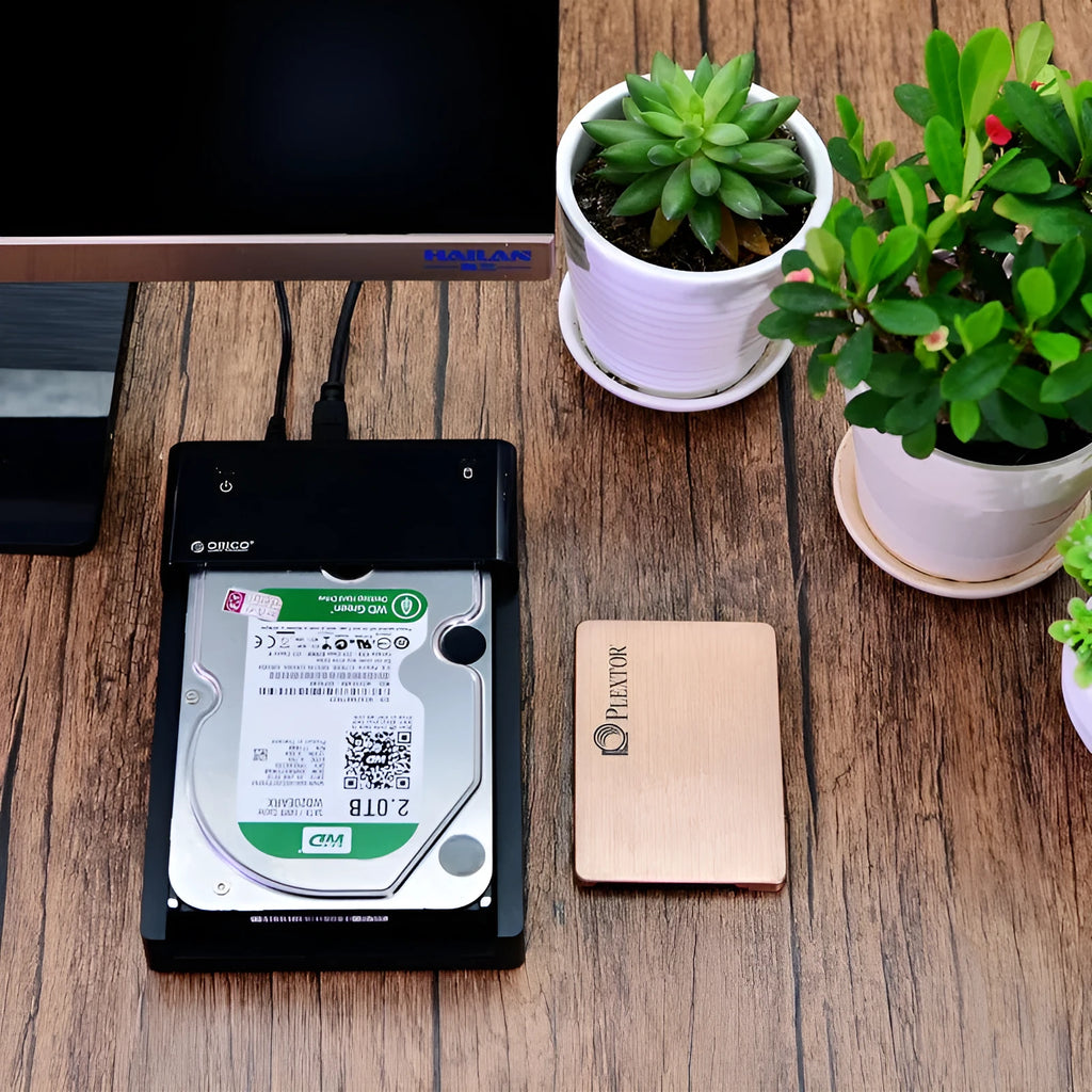 Black plastic universal hard disk enclosure for 2.5-inch and 3.5-inch SATA drives with data cable.