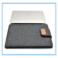 Dark grey felt plush clamshell laptop bag showing interior with corner protector and computer compartment