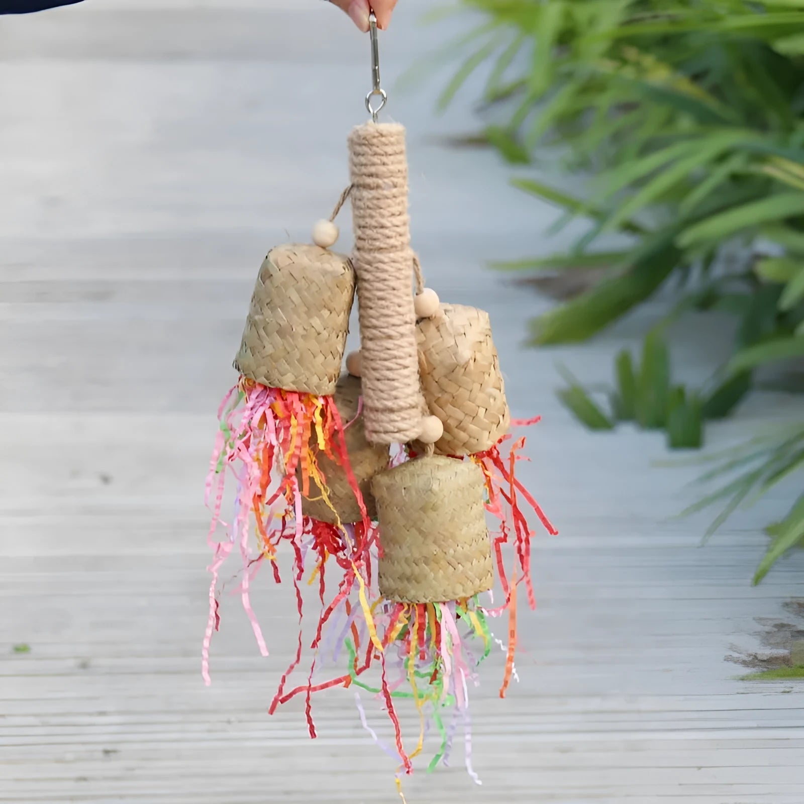 Colourful shredded paper and wood parrot hanging toy with sisal rope for medium birds.
