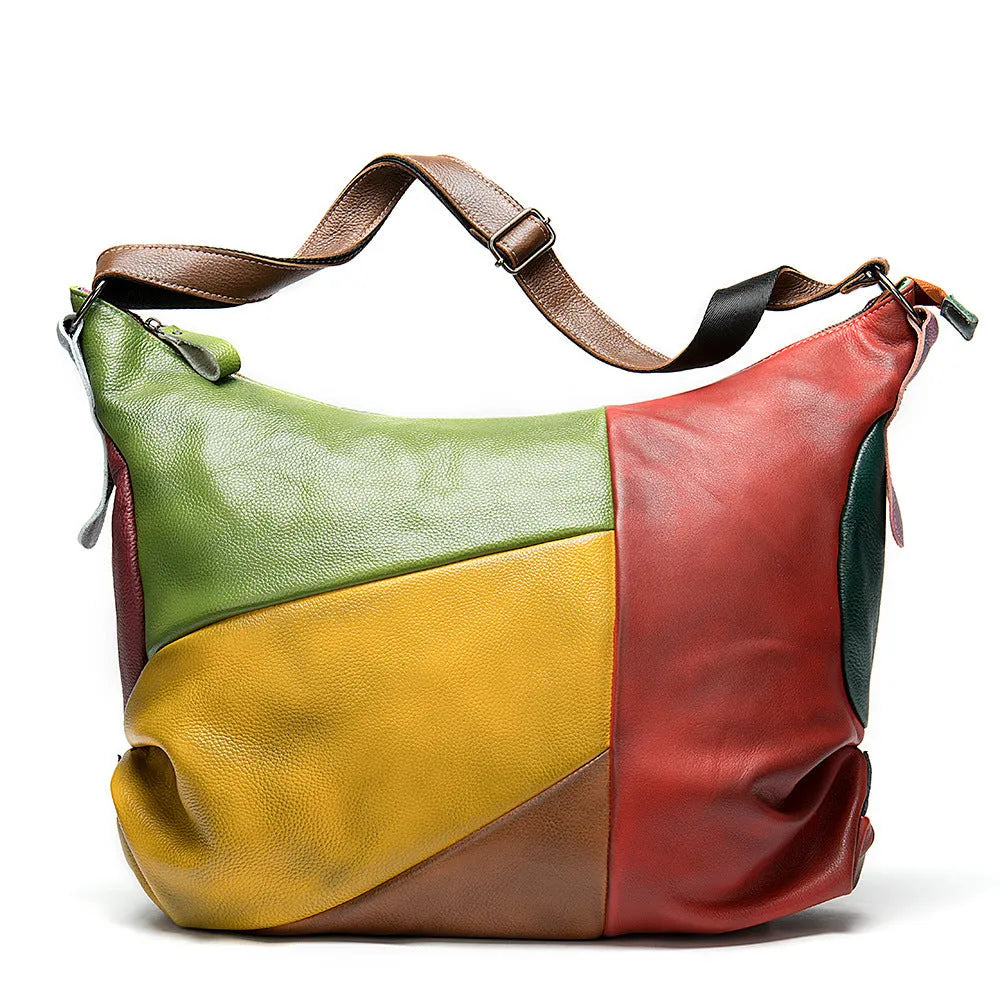 Brown cowhide leather crossbody travel bag open to show space for a laptop and A4 magazines.