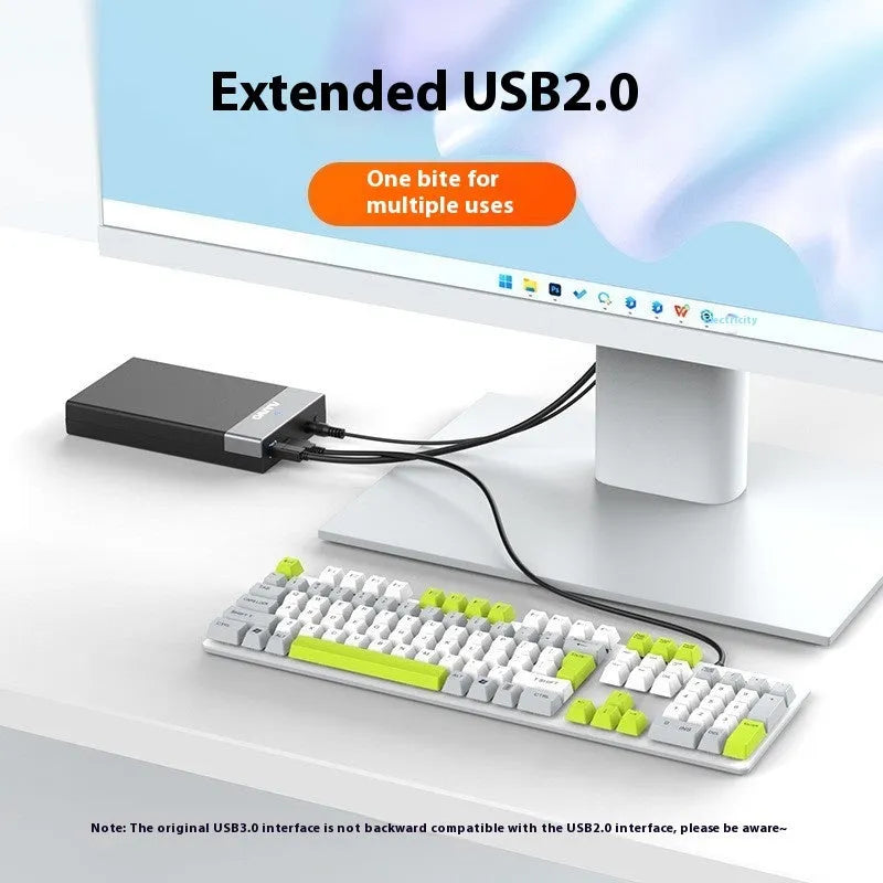 Black and silver 3.5 inch USB SATA hard drive enclosure with power supply and cable on a desk.