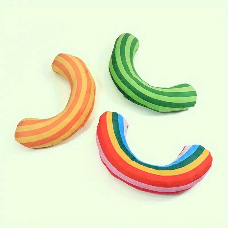 Set of four cat toys including a noise maker and a green striped catnip pillow on a neutral background.