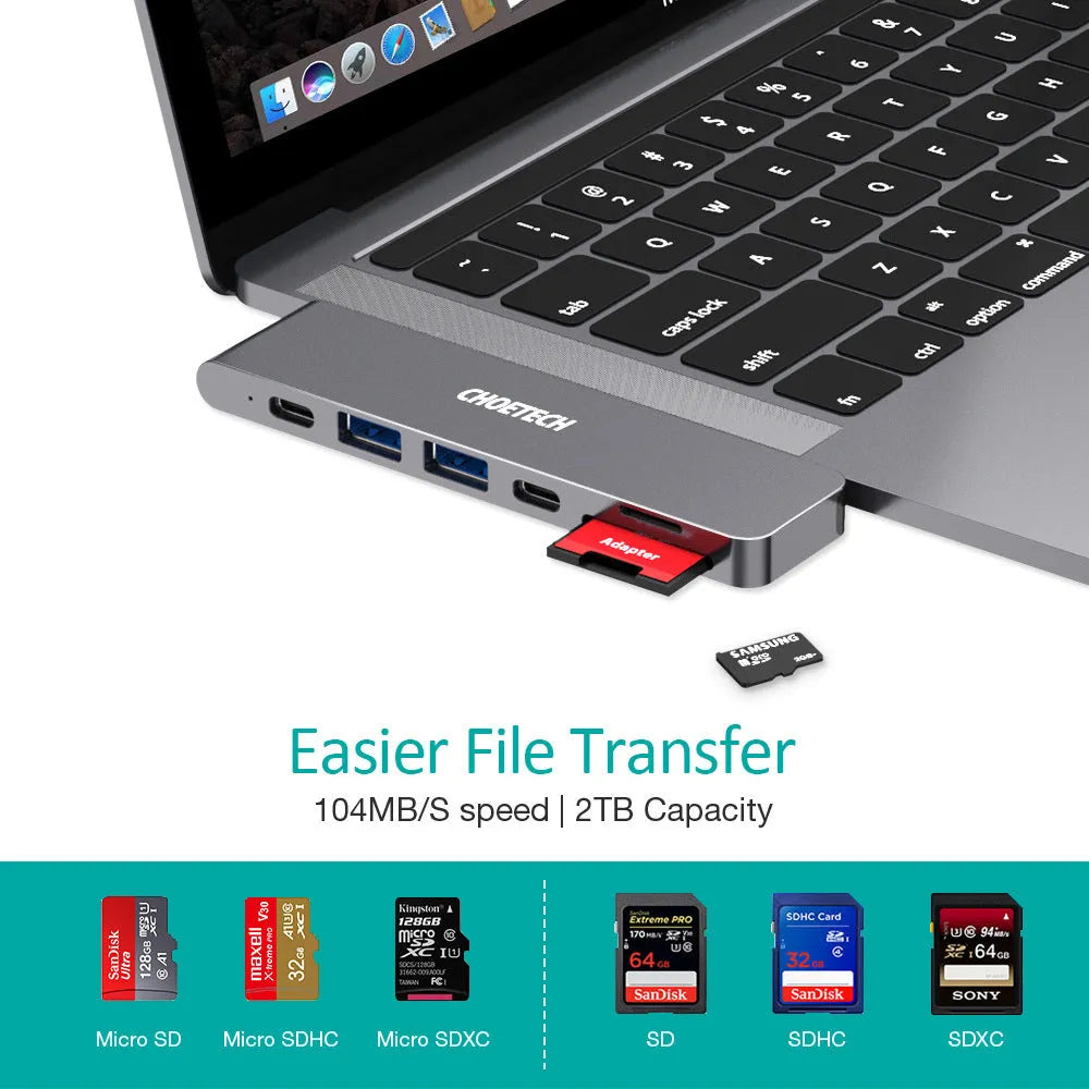 Silver aluminium 7-in-1 USB-C hub adapter with SD card slot, HDMI, USB 3.0, and charging ports.