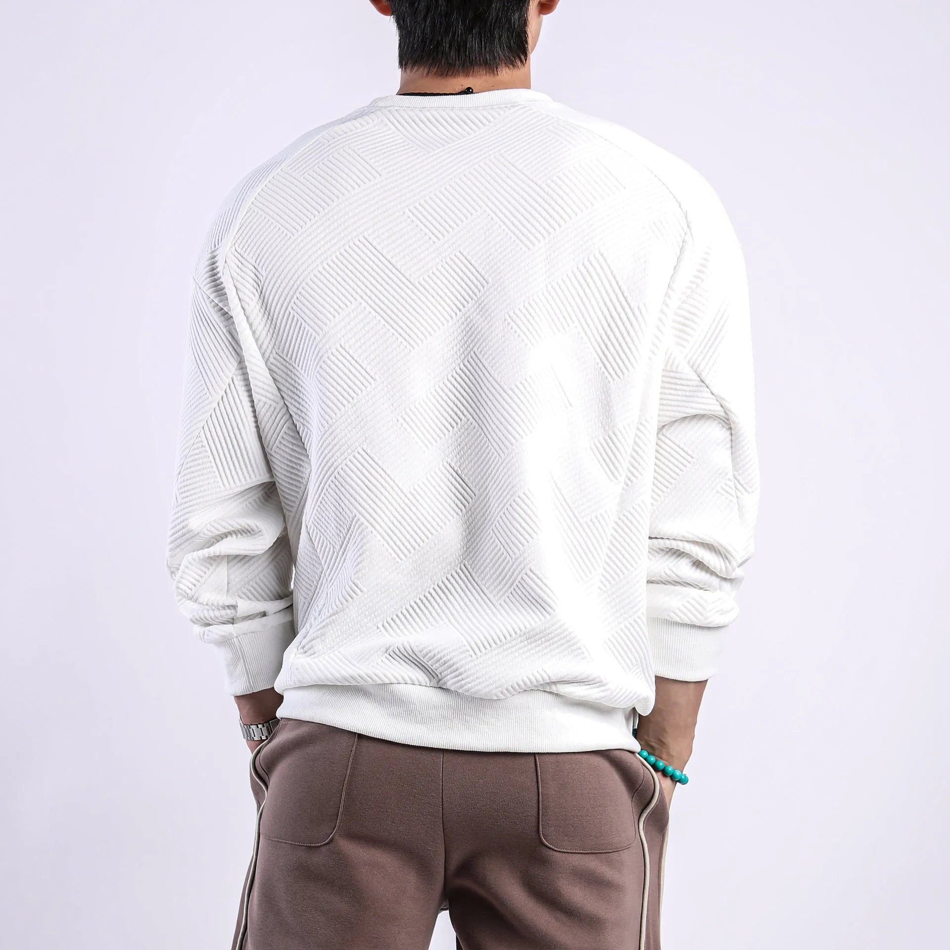 Men's loose fit long sleeve twill Jacquard sweater in solid colours on a hanger.