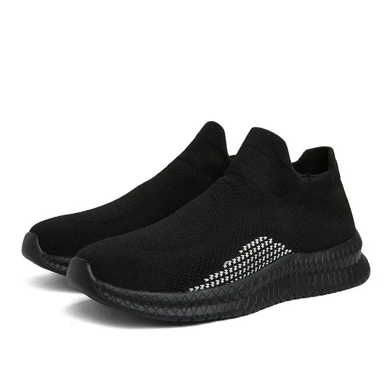 Solid colour flyknit style casual sneakers with fabric upper and low flat heel