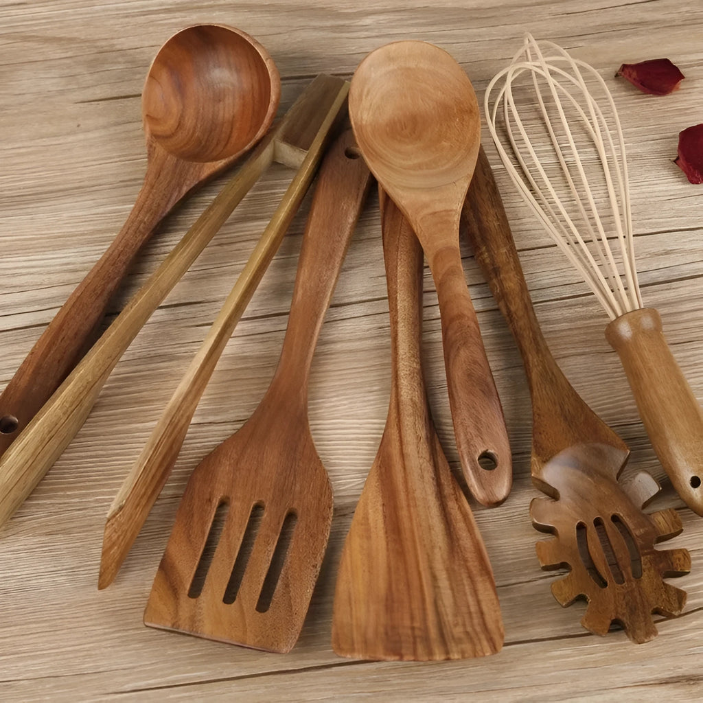 Set of 7 wooden cooking utensils including spoons and shovels arranged on a kitchen surface