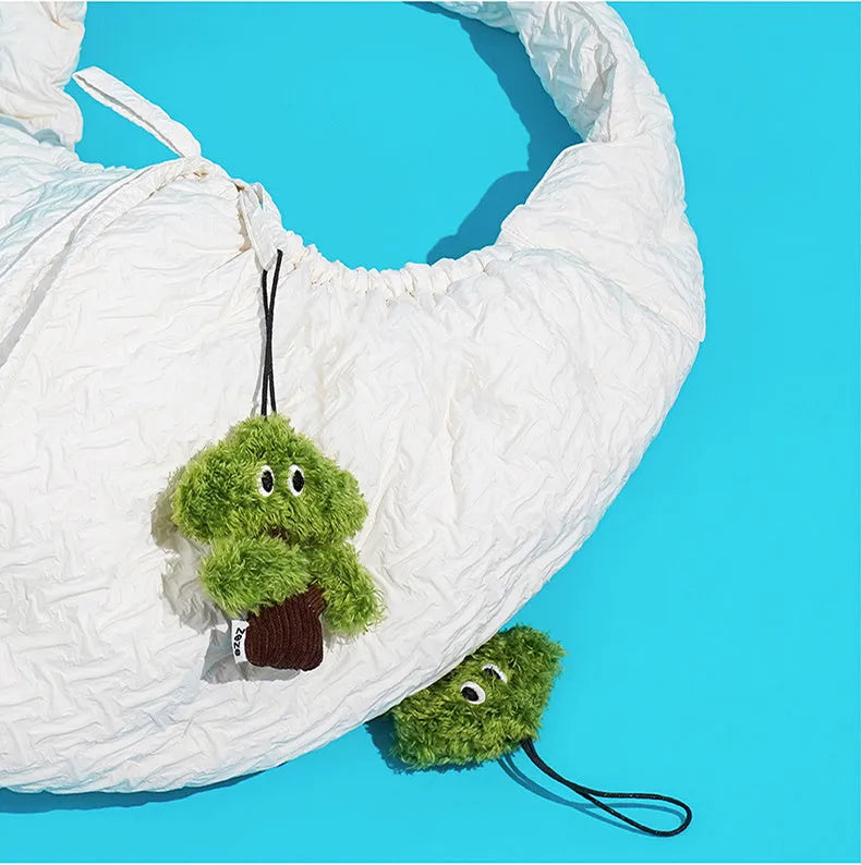 Green pine tree-shaped cat chew toy with a hanging loop, shown with size options.
