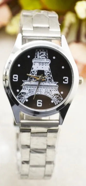 Eiffel Tower wrist watch with metal case and analogue display on metal strap with buckle closure.