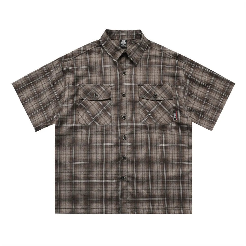 Men's black and brown plaid short sleeve shirt with embroidered lettering and lapel collar.