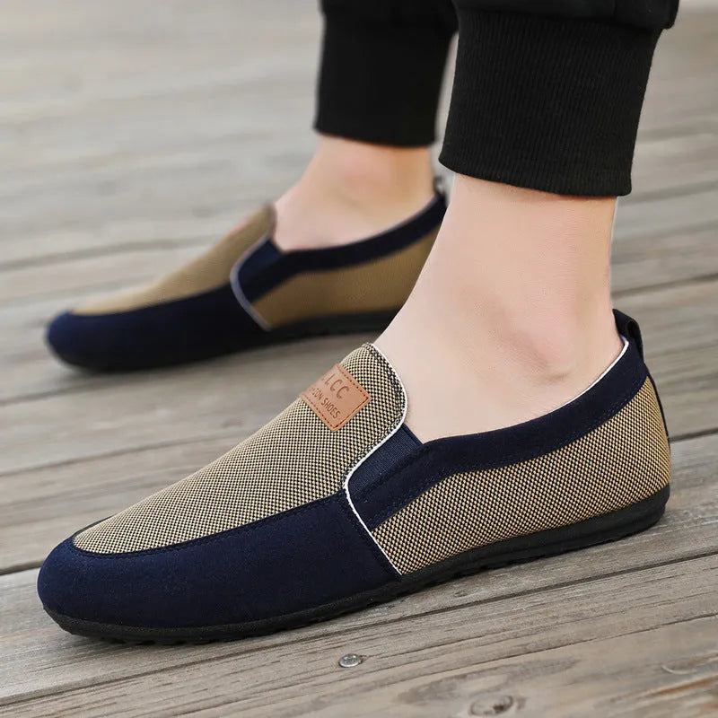 Men's grey canvas casual board shoes with round toe and rubber sole.