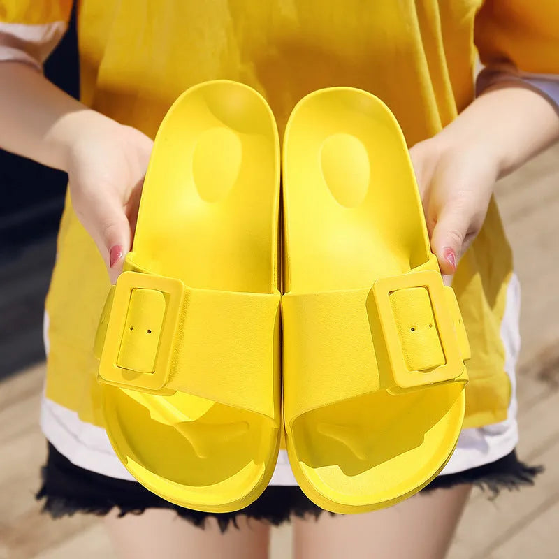 Women's EVA buckle fastening flip-flop slippers in assorted colours showing soft sole design
