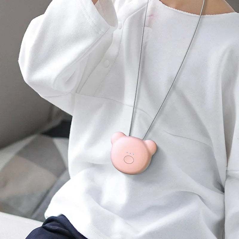 Mini USB portable air purifier necklace in pink, showing compact design with single button.