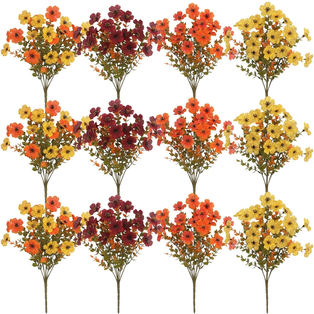 Artificial flower bouquet in autumn colours including orange, yellow, and red tones