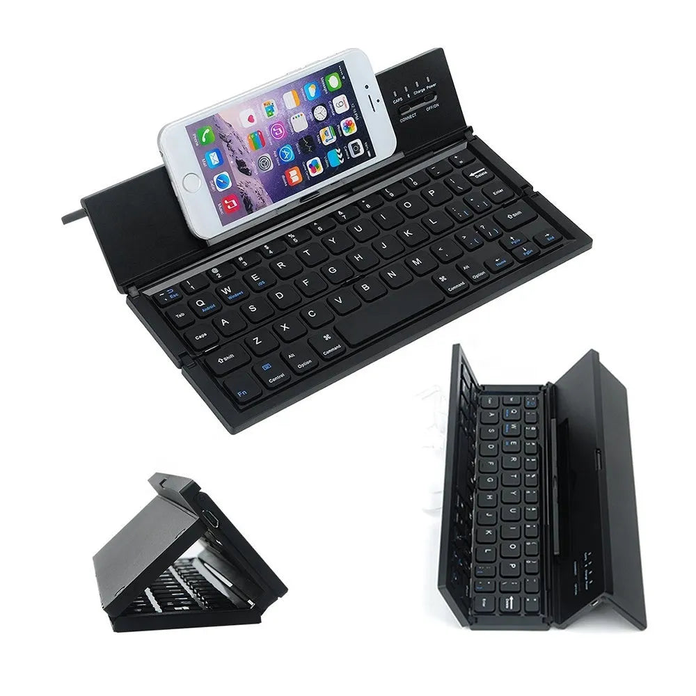 Black folding wireless Bluetooth keyboard shown open next to a tablet demonstrating its compact portable size.