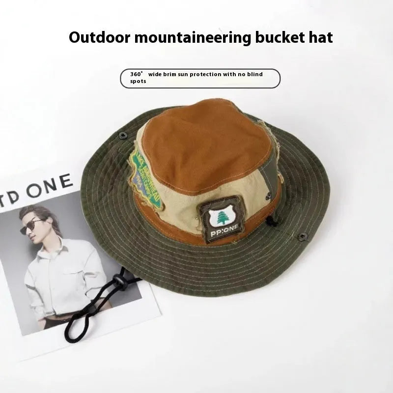 Army green foldable cotton fisherman hat with hand-painted patchwork design and flat top crown.
