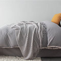 Small 127cm by 170cm polyester nap blanket shown in dark grey, khaki, and light grey colour options.