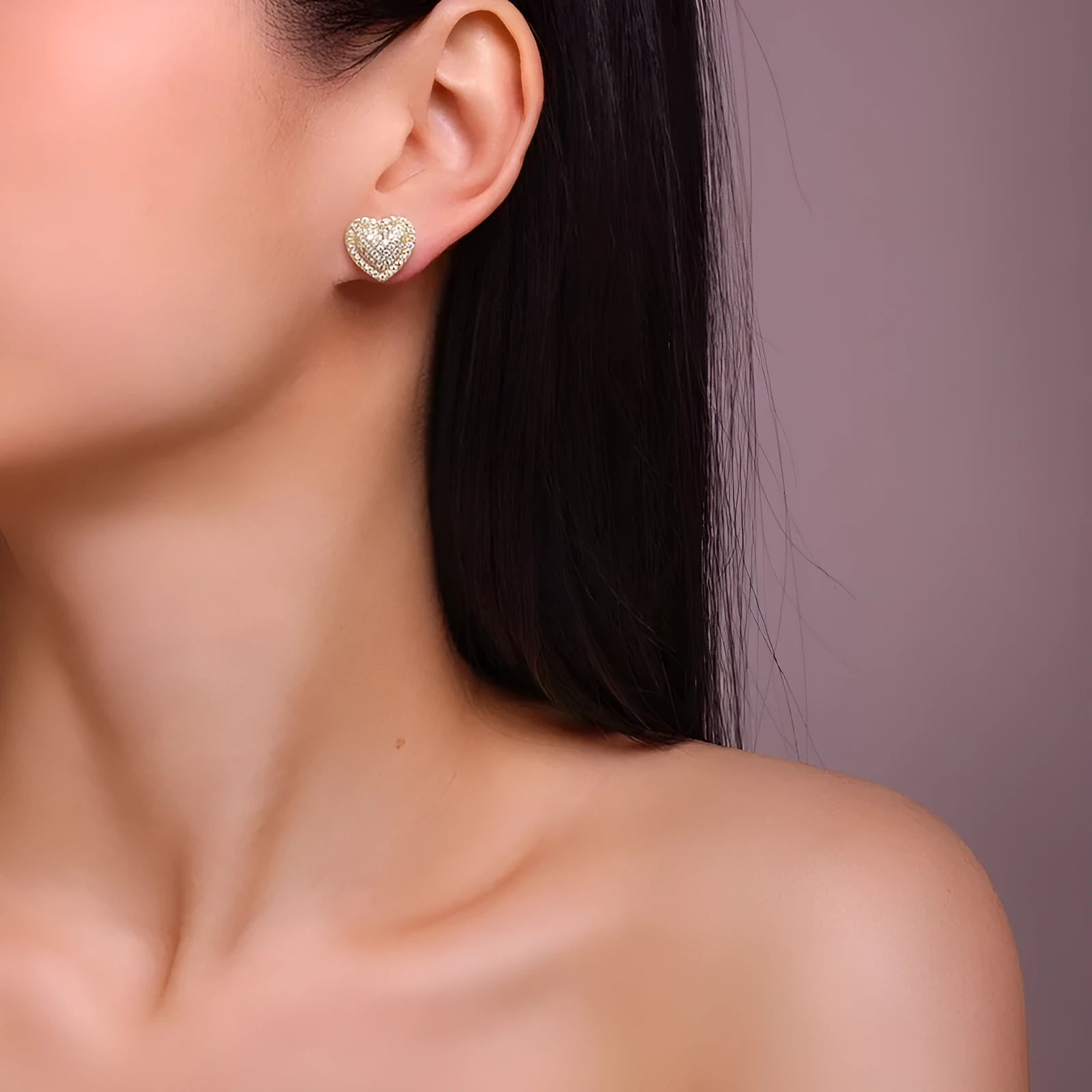 Golden heart-shaped stud earrings with moissanite stones on silver posts