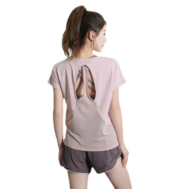 Women's short sleeve polyester sports t-shirt in pink, shown in a casual athletic style.