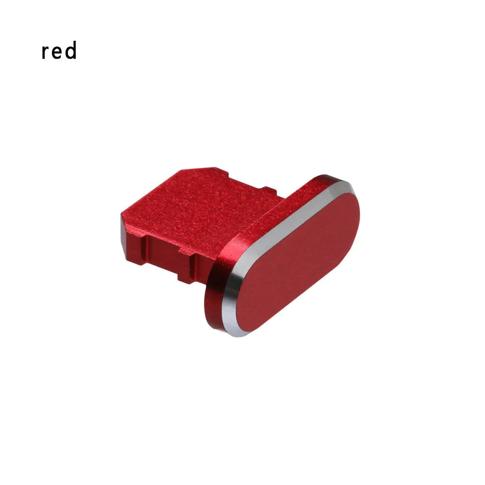 Aluminium alloy iPhone charging port dust plug in metallic colours on a dark background.