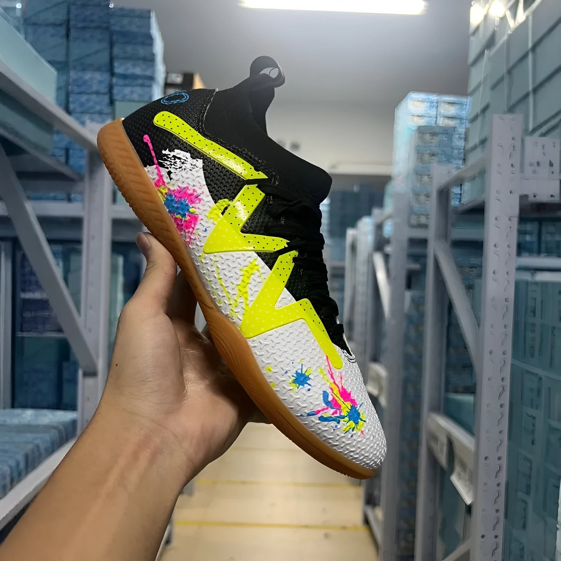 Adult low-top football boots in Black and Yellow colour with mesh lining and rubber sole.