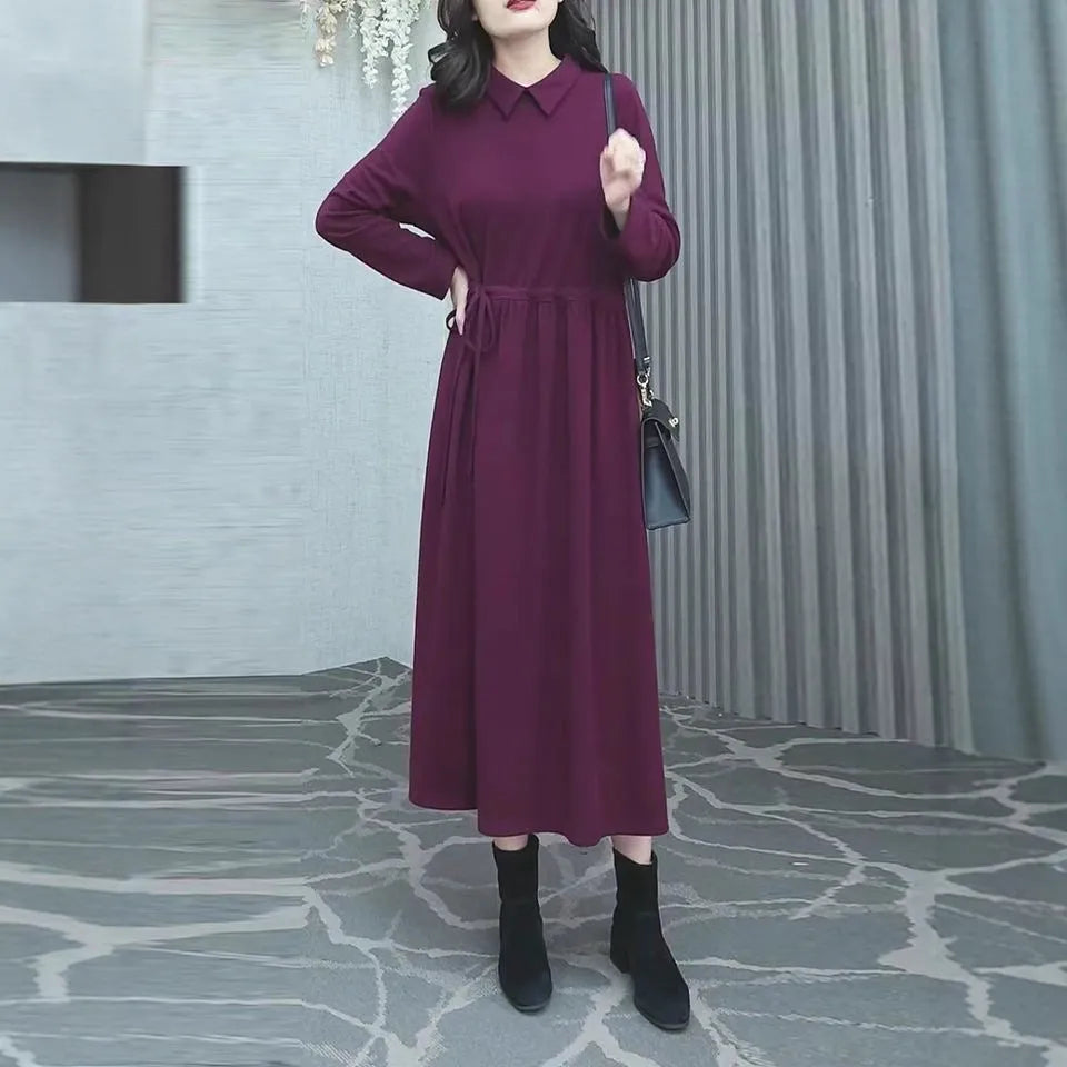 A purplish red plus size long sleeve dress for women, featuring a long skirt and urban commute style.
