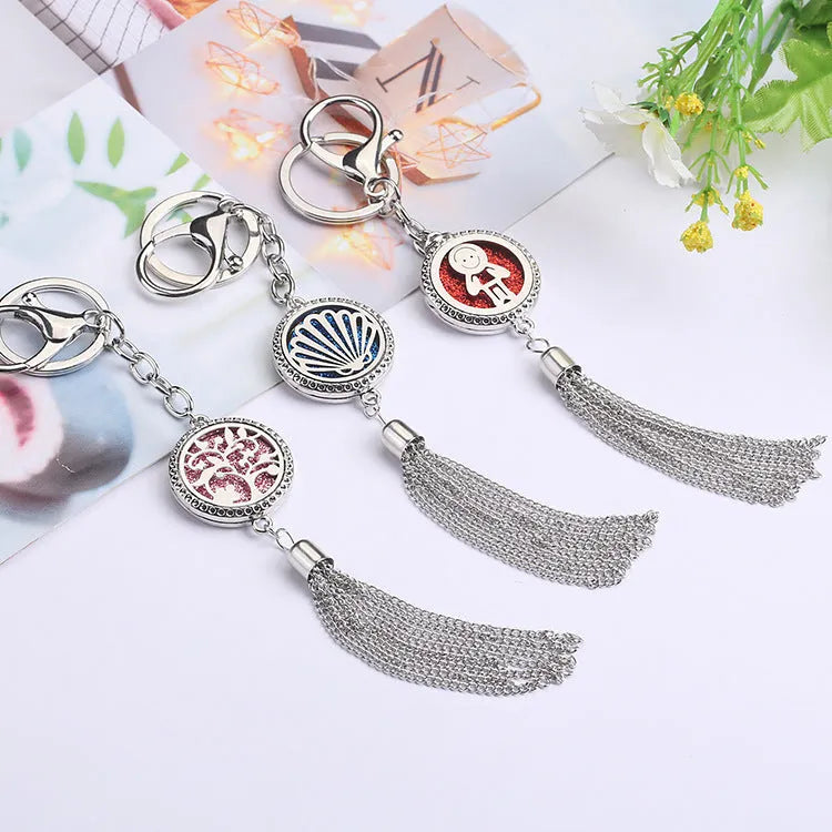 Alloy tassel-style car fragrance pendant with cotton pads hanging from rear-view mirror