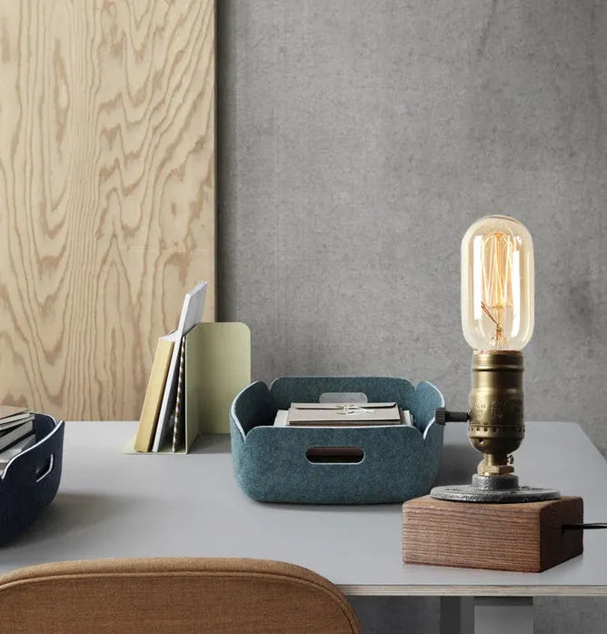 Industrial style wood and iron pipe table lamp with E26 socket on a wooden surface.