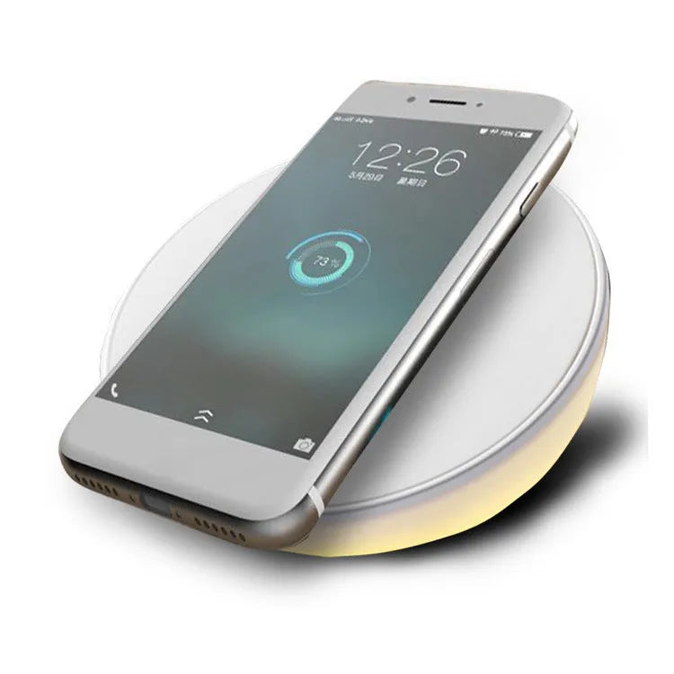 White wireless mobile phone charger with digital clock display showing the time