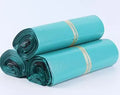 Bundle of 100 clear PE plastic courier clothing bags in multiple sizes with adhesive sticker seals.