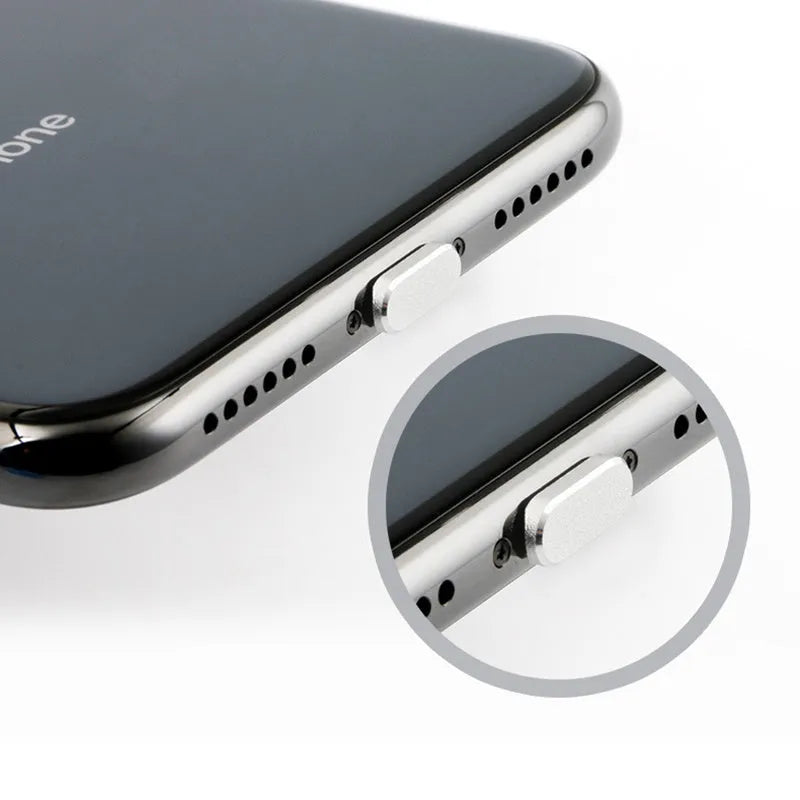 Aluminium alloy iPhone charging port dust plug in metallic colours on a dark background.