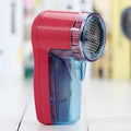 Portable electric clothing lint remover with compact rectangular design showing dimensions